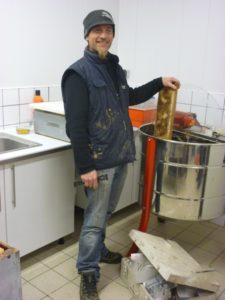 Renan Lecou dans la miellerie devant un extracteur de miel - GAEC Ty Askell - Buziet (64)